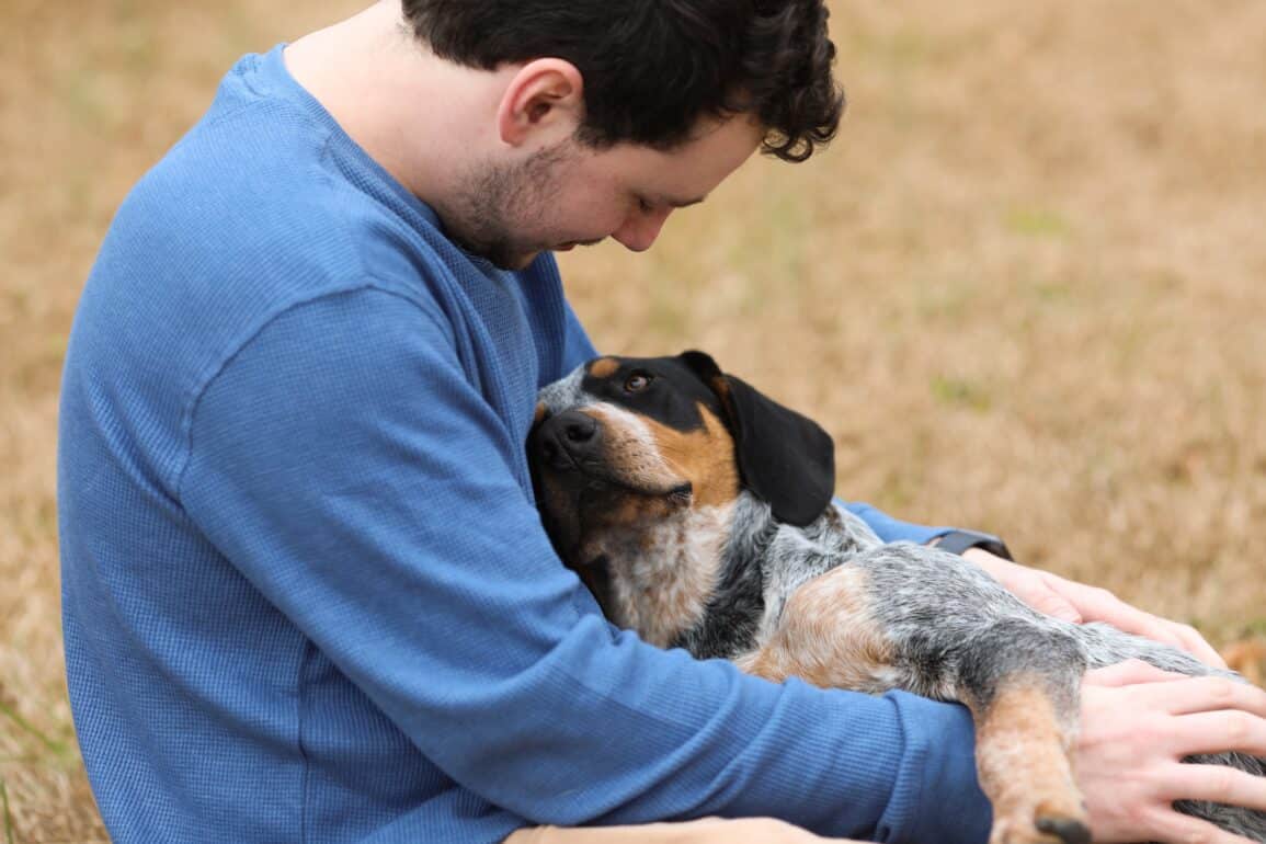 dog laying on man's lap