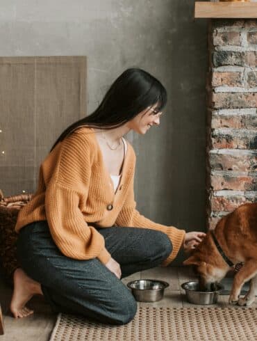 a woman feeding her dog
