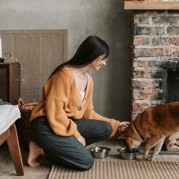 a woman feeding her dog